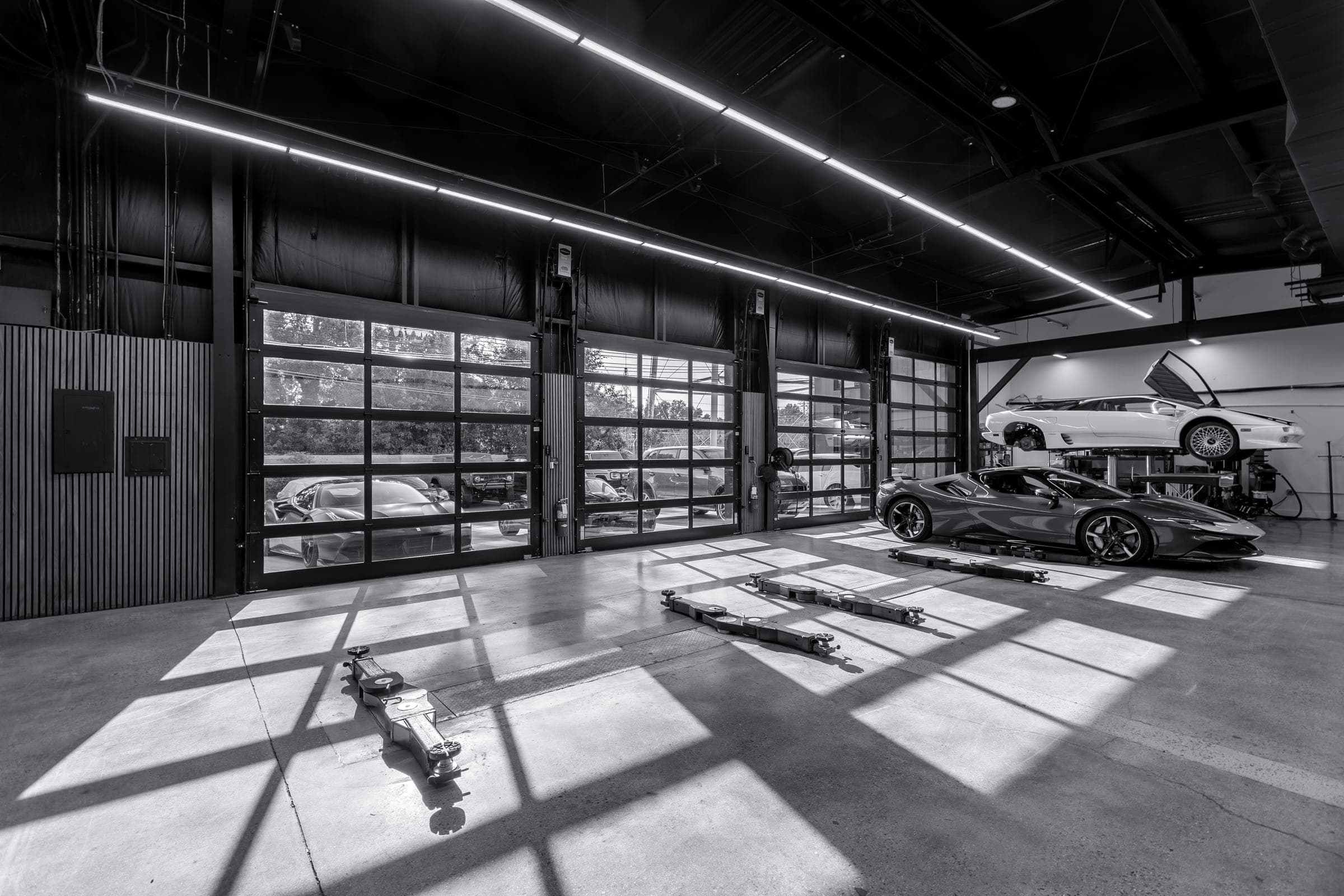 Eurowise service bay with a Ferrari and a Lamborghini Diablo on the lift